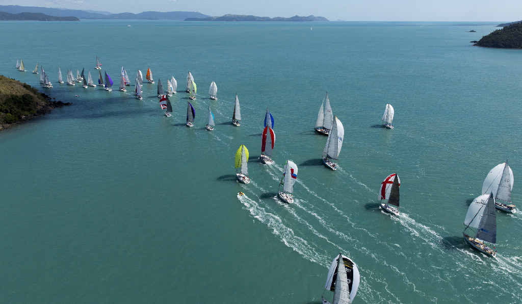 ISLAND PARADISE: Some of the fleet competing at Audi Hamilton Island Race Week head towards the Whitsunday Passage during last year’s race. Photo: Andrea Francolini